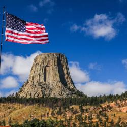 Drapeau américain flottant devant le monument national de Devils Tower au Wyoming, États-Unis.