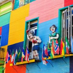 151687217-A-colorful-building-in-La-Boca-neighborhood-of-Buenos-Aires-with-statues-and-flags-C-Shutterstock.jpg